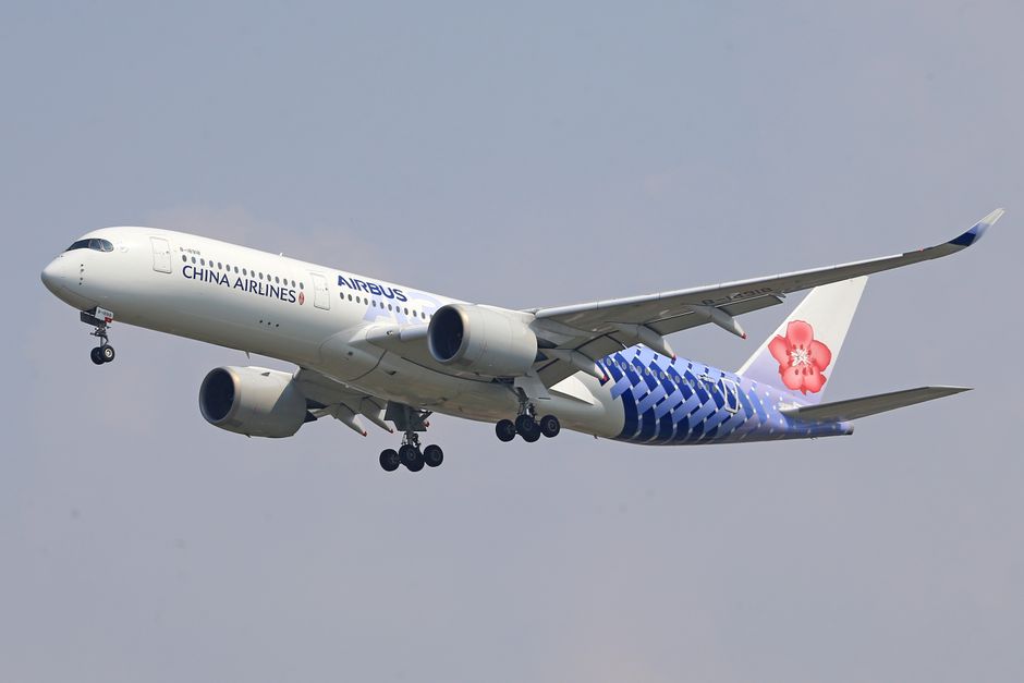 China Airlines Airbus A350 soaring through a bright blue sky during the day.